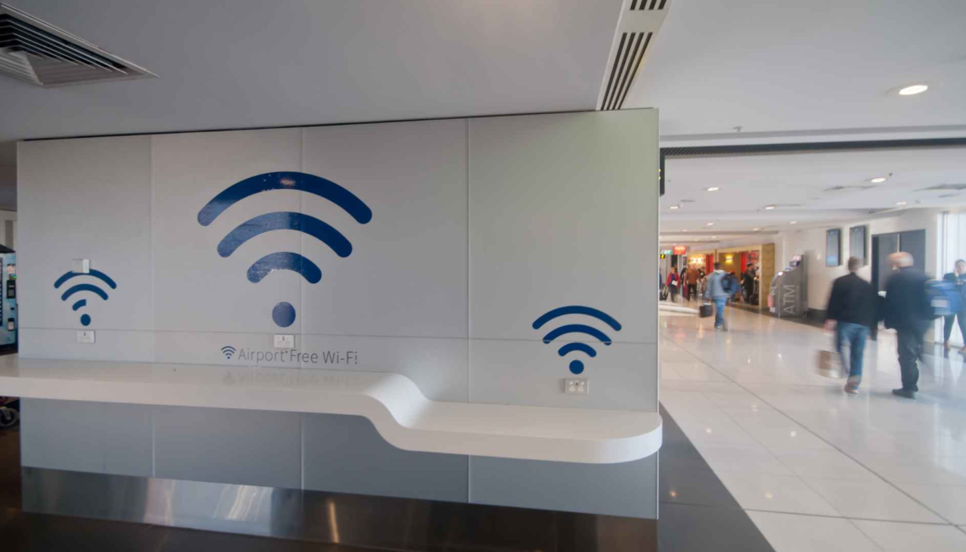 Traveler using public Wi-Fi safely on a laptop