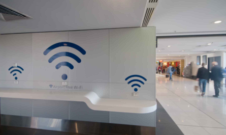 Traveler using public Wi-Fi safely on a laptop